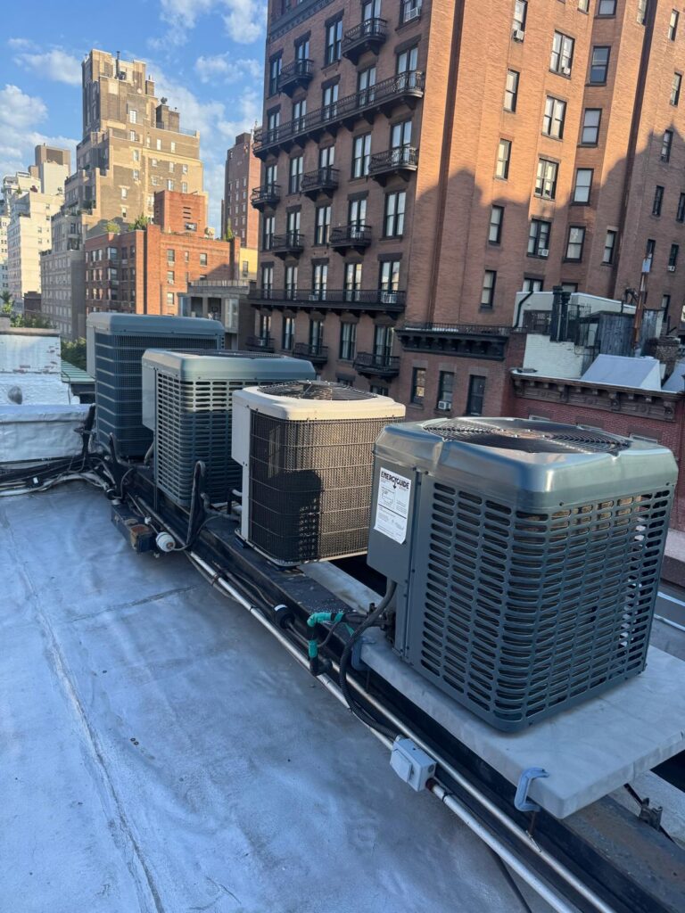 Rooftop air conditioning condenser units installed on a New York City building