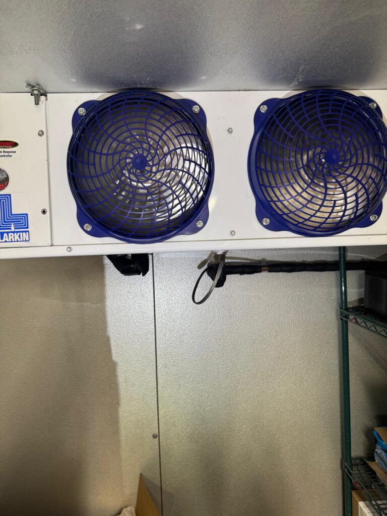 Walk-in cooler evaporator with dual fans installed for commercial refrigeration